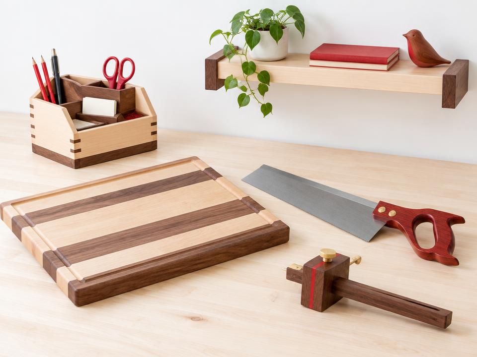 Finished projects on a pale bench: a striped cutting board, a small desk organizer and a floating shelf.